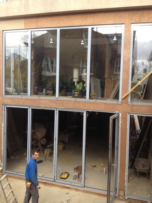 Aluminium bi-fold doors with two-storey glazing in Carshalton