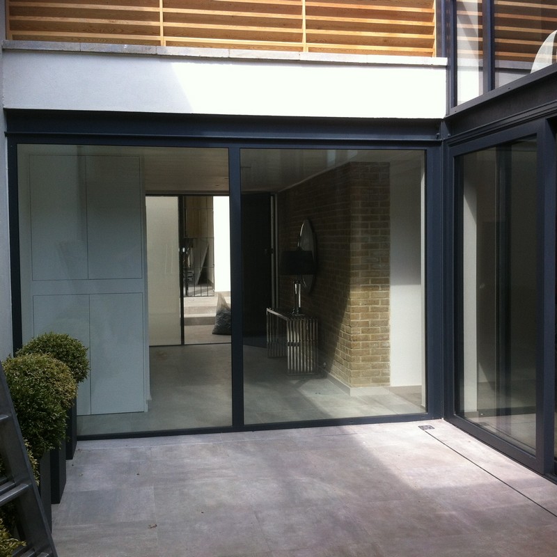Floor-to-ceiling sliding doors opening to courtyard in Carshalton