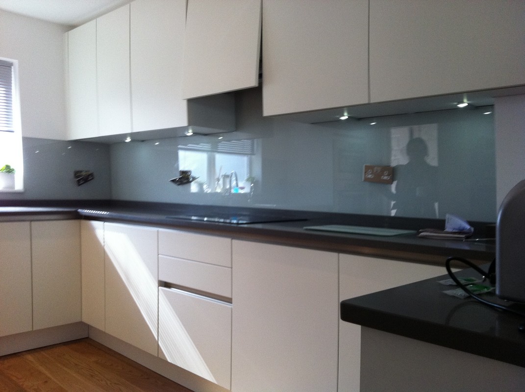 Grey glass kitchen splashback with LED lighting in Carshalton