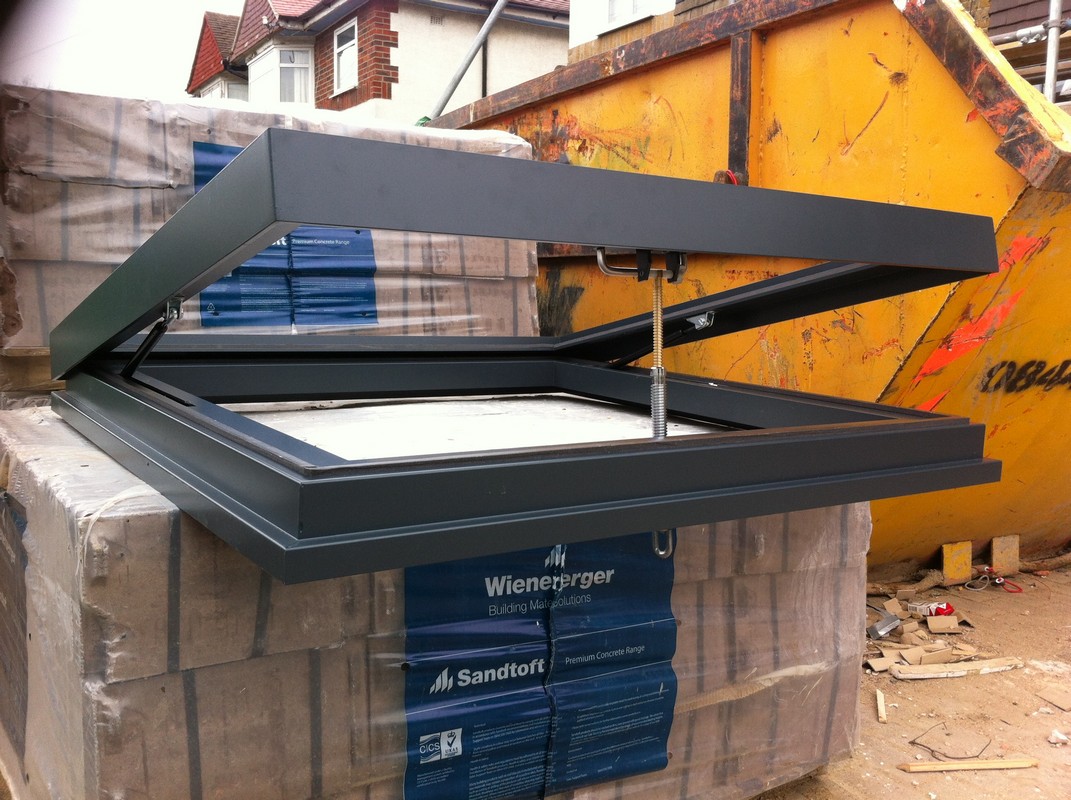 Opening flat roof skylight in anthracite grey installed in Carshalton