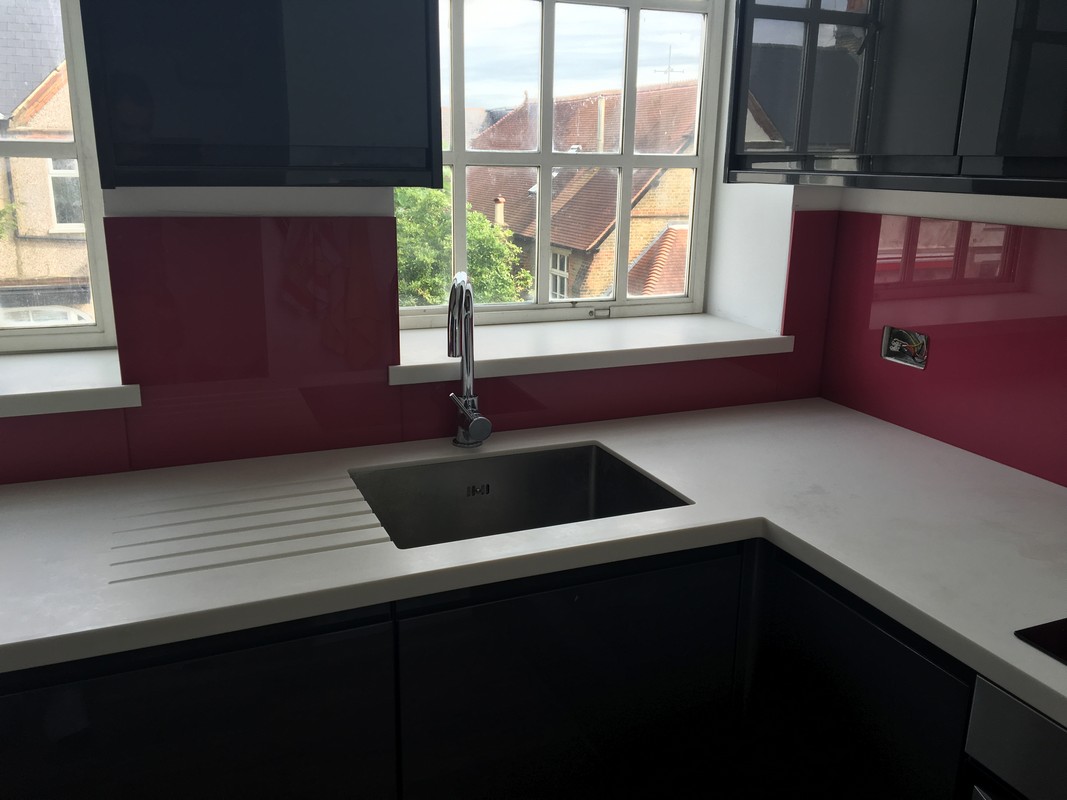 Deep plum coloured glass splashback in modern Carshalton kitchen
